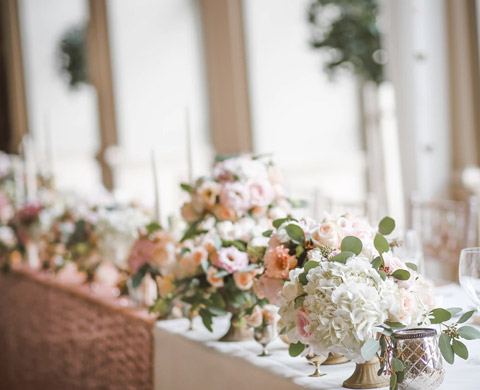 white pink flowers on head wedding table